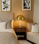 Neatly arranged bedroom with bed, nightstand, and lamp.
