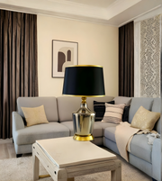 Modern living room with gray sofa, decorative lamp, and wall art.