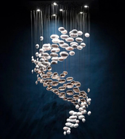 Modern chandelier with hanging glass orbs on a dark background