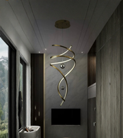 Modern interior with a gold spiral pendant light fixture.