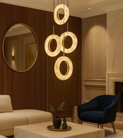 Modern living room with a stylish pendant light fixture, beige sofa, and blue armchair.