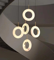 Modern pendant light with circular design on a dark background