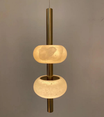 Modern pendant light with two round glass shades on a gray background