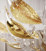 Decorative wall art with gold and silver leaf designs on a white background