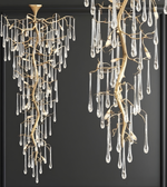 Decorative chandeliers with branch-like design and hanging crystals on a dark background