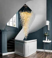 Modern staircase with a decorative chandelier in a stylish interior setting.