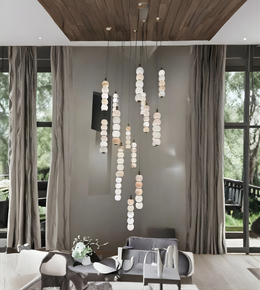 Modern living room with a stylish chandelier, gray sofa, and large windows.