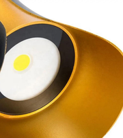 Close-up of a yellow and black object with a white center and yellow dot on a white background