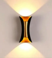Modern wall light fixture with a geometric design on a plain background