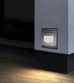 Lighting fixture on a wall casting a warm glow on the floor
