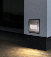 Lighting fixture on a wall casting a warm glow on the floor