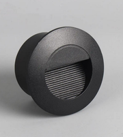 Round black outdoor light fixture on a gray background