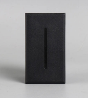 Black rectangular block with a central cutout on a light gray background