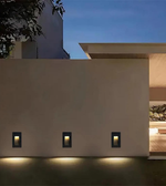 Modern building exterior with wall-mounted lights at night
