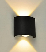 Black wall-mounted light fixture on a gray wall