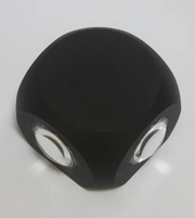 Black die with white pips on a light gray background