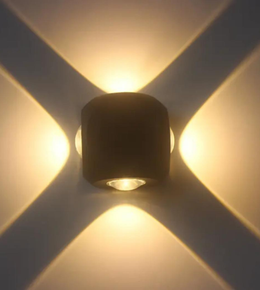 Wall-mounted light fixture casting shadows on a wall