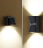 Two wall-mounted lights on a beige wall, one on the left and one on the right.