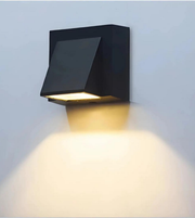 Black outdoor wall light fixture on a light gray background