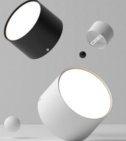 Modern cylindrical light fixtures on a gray background