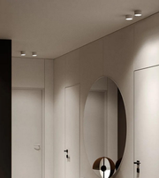 Modern interior with a round mirror on a white wall.