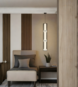 Modern interior with a pendant light, chair, and small table.