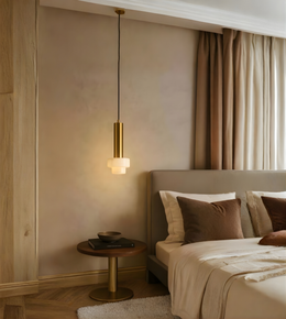 Modern bedroom with a pendant light, bed, and side table.