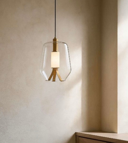 Modern pendant light with glass shade and wooden fixture on a neutral wall.