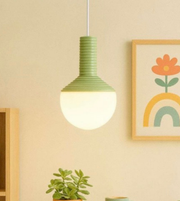 Green pendant light fixture on a beige wall with a colorful painting of a flower and rainbow.