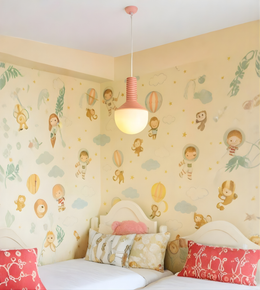 Children's bedroom with cartoon-themed wallpaper and colorful bedding.