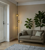 Modern living room with a gray sofa, decorative plants, and a hanging light fixture.