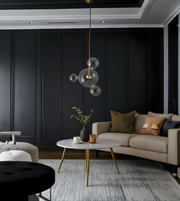 Modern living room with dark walls, a beige sofa, and decorative elements.