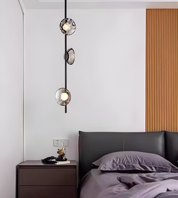 Modern bedroom with a bed, nightstand, and decorative wall light fixture.