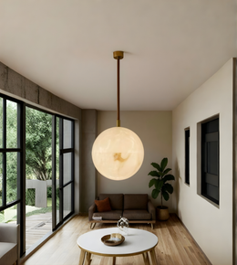 Modern living room with a pendant light, sofa, and large windows.