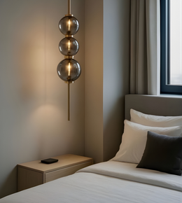 Modern bedroom with a pendant light fixture, bed, and nightstand.