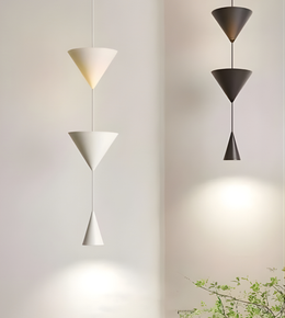 Three modern pendant lights on a neutral background
