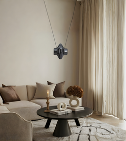 Modern living room with a beige sofa, coffee table, and decorative items.