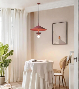 Dining room with a round table, chairs, and a pendant light.