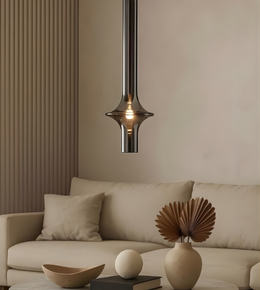 Modern pendant light hanging above a beige sofa in a living room setting.