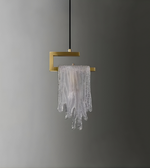 Modern pendant light with gold fixture and glass shade on a gray background