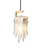 Modern pendant light with gold fixture and glass shade on a white background