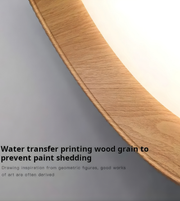 Wooden surface with water transfer printed wood grain pattern on a gray background
