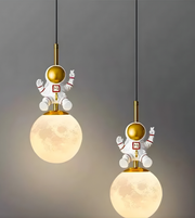 Two pendant lights with astronaut figures on a gray background