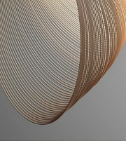 Close-up of a curved metallic surface with concentric circular patterns on a gray background