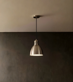 Pendant light hanging from a ceiling with a dark and light gradient background