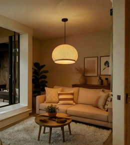 Living room with beige sofa, round coffee table, and pendant light.