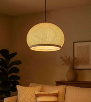 Woven pendant light hanging in a cozy living room with warm lighting.