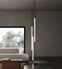 Modern floor lamp in a minimalistic living room with a sofa and window view.