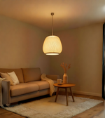 Living room with beige sofa, wooden side table, and pendant light.
