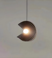 Modern pendant light with a circular design on a neutral background